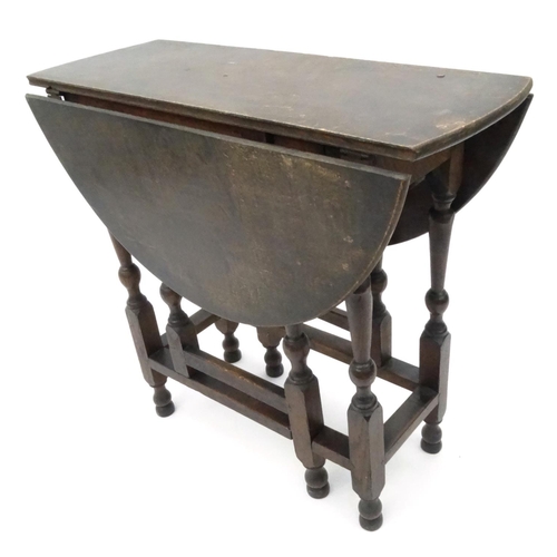 25 - Antique oval oak gateleg table, 70cm high x 90cm wide x 75cm deep