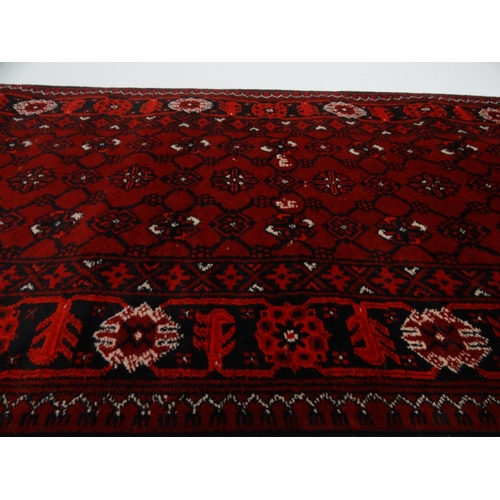 30 - Red ground geometric patterned carpet runner, approximately 300cm x 82cm