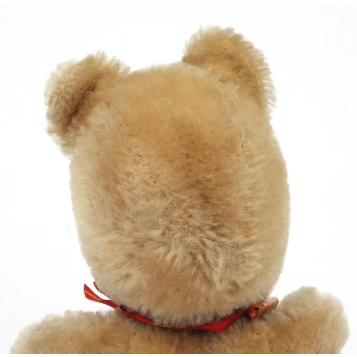 632 - 1950s straw filled Winnie the Pooh bear with beaded glass eyes, together with a small straw filled d... 