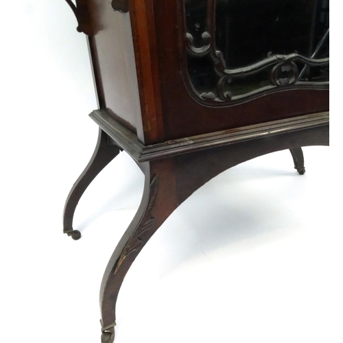 9 - Ornate Edwardian mahogany display cabinet with mirrored back and glazed door enclosing two velvet li... 