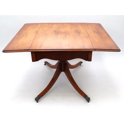 42 - Yew wood dropleaf dining table with brass paw feet, 74cm high x 120cm wide (when extended) x 102cm d... 