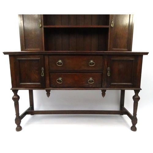 20 - Oak dresser with an arrangement of shelves and cupboards, 197cm high x 152cm wide x 56cm deep