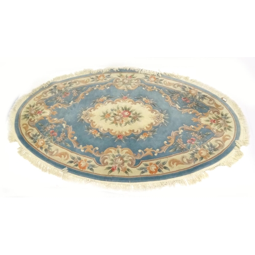44 - Large oval cream and blue ground floral rug, approximatelky 260cm x 160cm