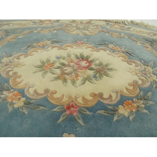 44 - Large oval cream and blue ground floral rug, approximatelky 260cm x 160cm