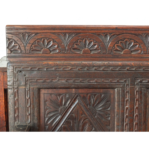 3 - Oak monk's bench with lozenge and floral carved panels, 127cm high x 126cm wide x 56cm deep