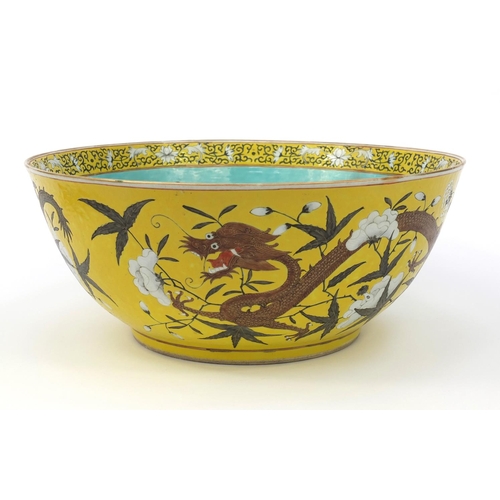 560 - Large oriental Chinese porcelain punch bowl hand painted with dragons and flowers, character mark to... 