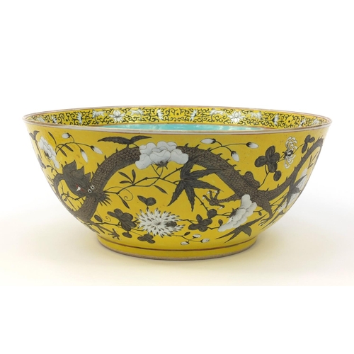 560 - Large oriental Chinese porcelain punch bowl hand painted with dragons and flowers, character mark to... 