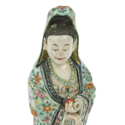 562 - Oriental Chinese stoneware figure standing on a mythical beast, the robe hand painted with flowers, ... 