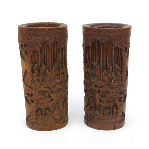 652 - Pair of wooden oriental Chinese bamboo brush pots carved with figures and landscape, 26cm high