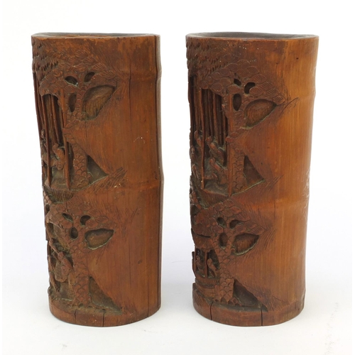 652 - Pair of wooden oriental Chinese bamboo brush pots carved with figures and landscape, 26cm high