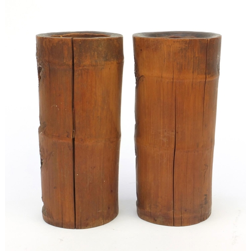 652 - Pair of wooden oriental Chinese bamboo brush pots carved with figures and landscape, 26cm high