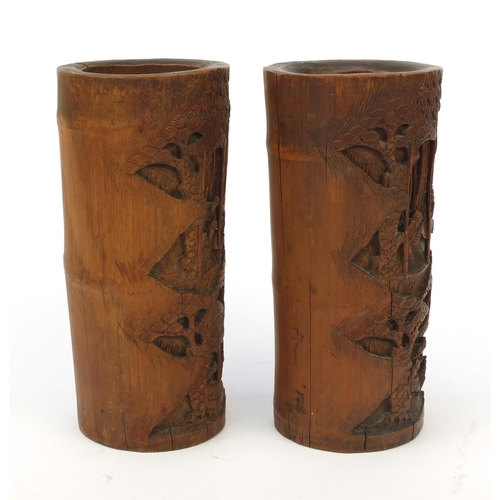 652 - Pair of wooden oriental Chinese bamboo brush pots carved with figures and landscape, 26cm high