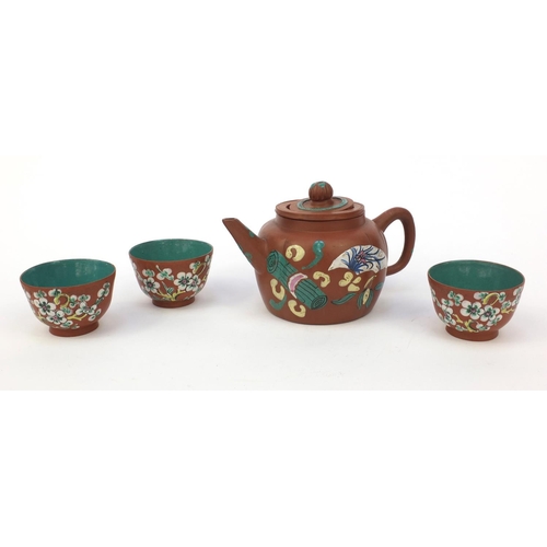 588 - Oriental Chinese Yixing pottery teapot hand enamelled with a panel of flowers and objects, character... 