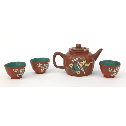 588 - Oriental Chinese Yixing pottery teapot hand enamelled with a panel of flowers and objects, character... 