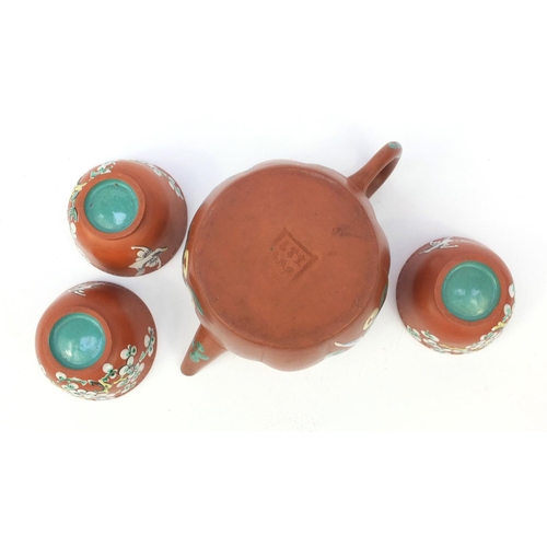 588 - Oriental Chinese Yixing pottery teapot hand enamelled with a panel of flowers and objects, character... 