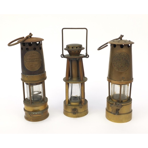 185 - Three brass miner's lamps including Halewoods Improved example, the largest 28cm high