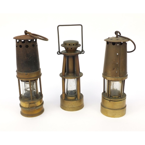 185 - Three brass miner's lamps including Halewoods Improved example, the largest 28cm high