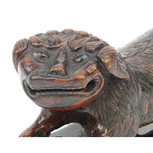 659 - Oriental Chinese wooden scribe's arm rest modelled as a dog of Foo, 20cm diameter