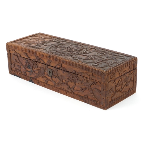 657 - Oriental Chinese hardwood box carved with dragons and flowers, 30cm wide