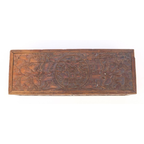 657 - Oriental Chinese hardwood box carved with dragons and flowers, 30cm wide