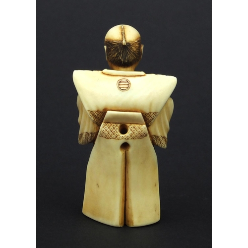 612 - Oriental Japanese ivory Netsuke of a robed elder holding a pot, with moveable head, 5cm high