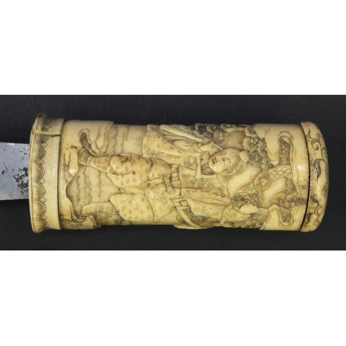 623 - Oriental carved bone dagger profusely carved with robed figures climbing a tree, 27.5cm long