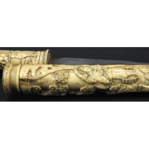 623 - Oriental carved bone dagger profusely carved with robed figures climbing a tree, 27.5cm long