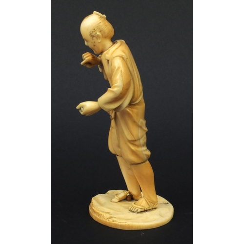 609 - Oriental Japanese carved ivory okimono of a tradesman, red seal mark to base, 15cms high