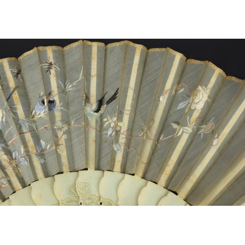 616 - Oriental Chinese Canton ivory fan carved with figures and flowers, the silk embroidered with birds a... 