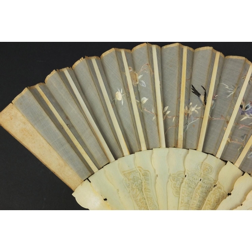 616 - Oriental Chinese Canton ivory fan carved with figures and flowers, the silk embroidered with birds a... 