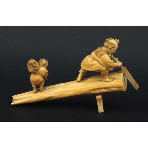 599 - Oriental Japanese carved ivory okimono of an elder and child standing on a tree trunk, the elder cut... 