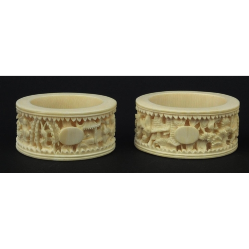 626 - Four oriental Chinese Canton ivory napkin rings carved with figures, each 6.5cm diameter