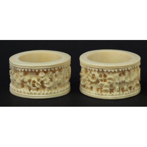 626 - Four oriental Chinese Canton ivory napkin rings carved with figures, each 6.5cm diameter