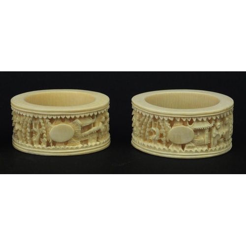 626 - Four oriental Chinese Canton ivory napkin rings carved with figures, each 6.5cm diameter