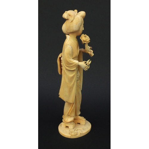 600 - Oriental Japanese carved ivory okimono of a geisha girl, red character mark to base, 30cm high