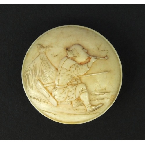 625 - Oriental ivory button carved with a pipe smoking man, 3cm diameter