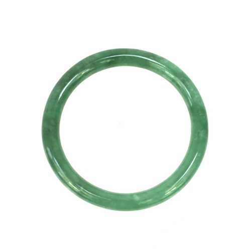 636 - Oriental green jade bangle, 7.5cm diameter