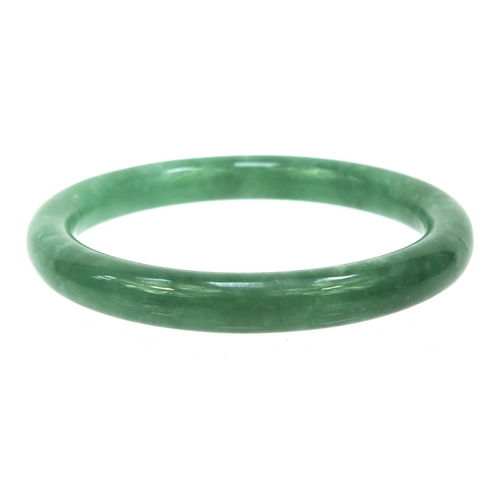 636 - Oriental green jade bangle, 7.5cm diameter