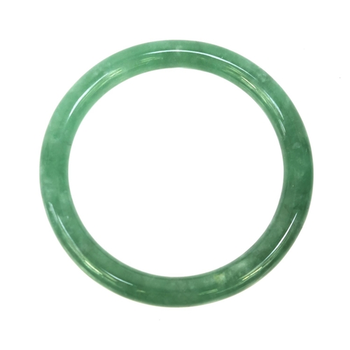 636 - Oriental green jade bangle, 7.5cm diameter