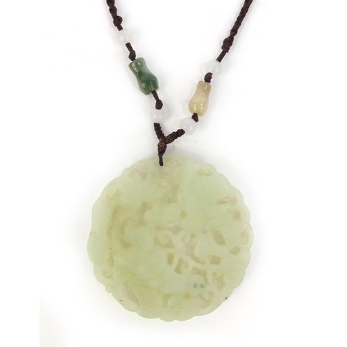 638 - Oriental Chinese jade pendant necklace pierced and carved with figures, 5cm diameter