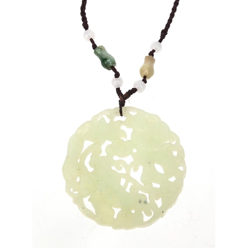 638 - Oriental Chinese jade pendant necklace pierced and carved with figures, 5cm diameter