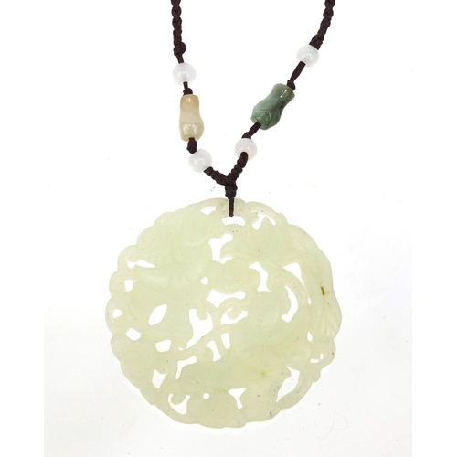 638 - Oriental Chinese jade pendant necklace pierced and carved with figures, 5cm diameter