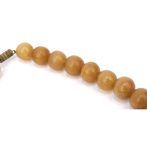 630 - Oriental Chinese rhino horn beaded necklace, the largest bead 2.5cm diameter