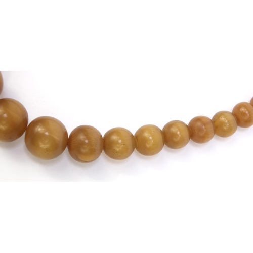 630 - Oriental Chinese rhino horn beaded necklace, the largest bead 2.5cm diameter