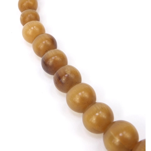 630 - Oriental Chinese rhino horn beaded necklace, the largest bead 2.5cm diameter