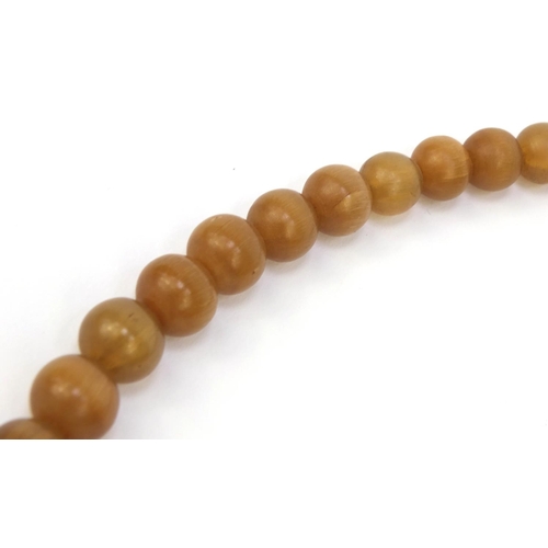 630 - Oriental Chinese rhino horn beaded necklace, the largest bead 2.5cm diameter