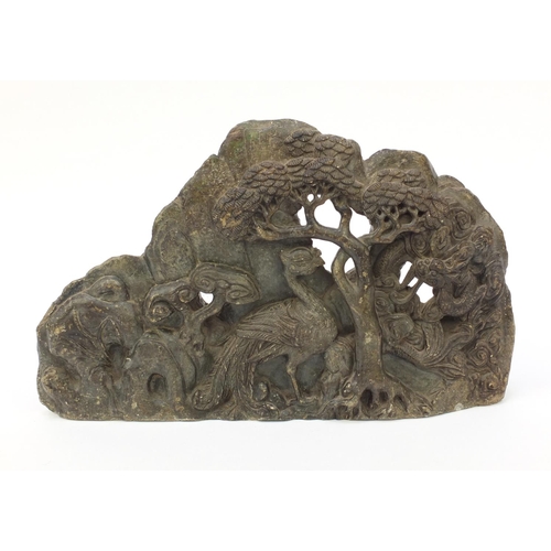 643 - Large oriental carved soapstone group of dragons and birds amongst trees, 39cm wide