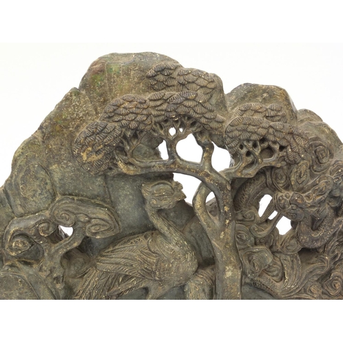 643 - Large oriental carved soapstone group of dragons and birds amongst trees, 39cm wide