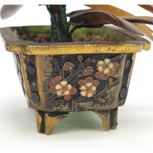 680 - Two oriental Chinese enamel pots with hard stone flowers mounted on a wooden stand, the stand 18cm w... 