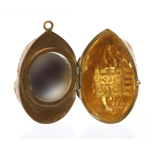 100 - Lady's pendant brass compact in the form of a nut with mirrored interior, 4cm wide